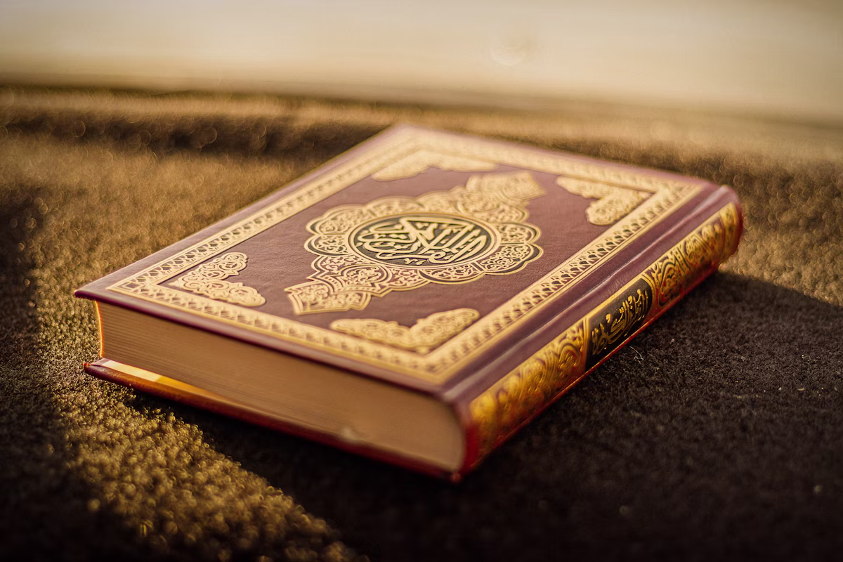 Noble Quran book open on a wooden stand